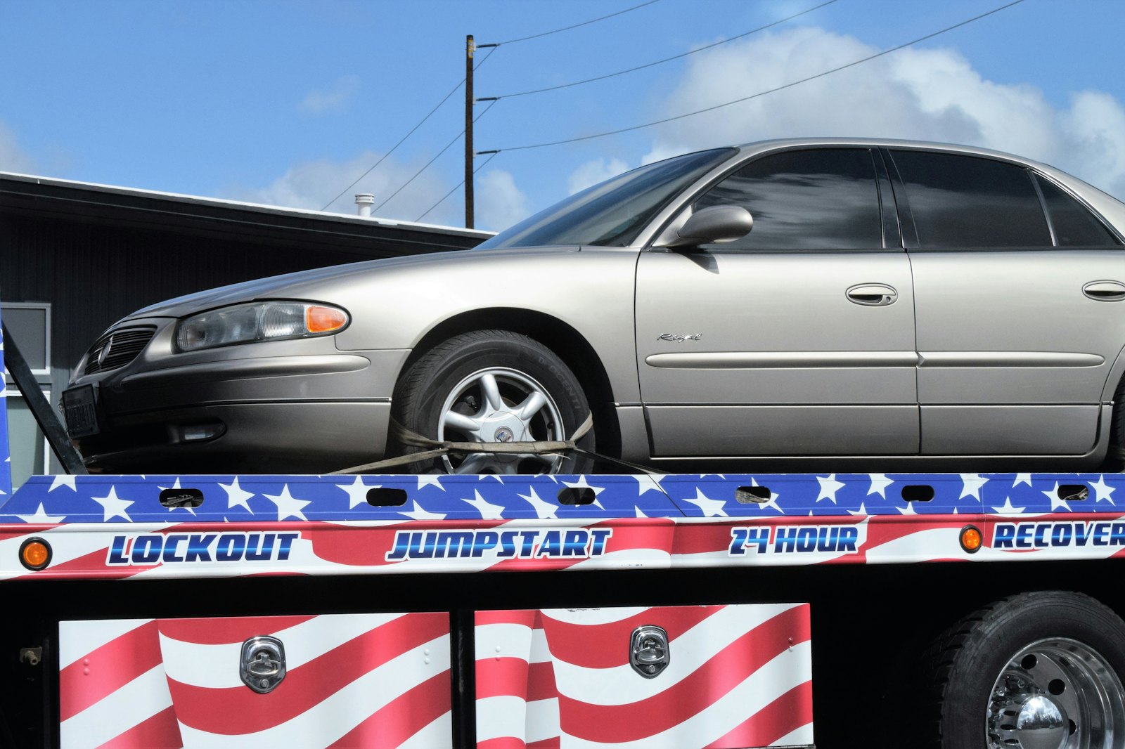 A car being loaded onto a flatbed tow truck